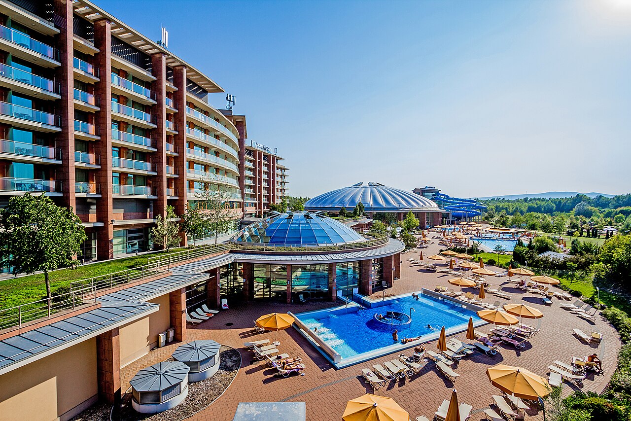 The outdoor pool area and grass at Aquaworld Resort Budapest in summer