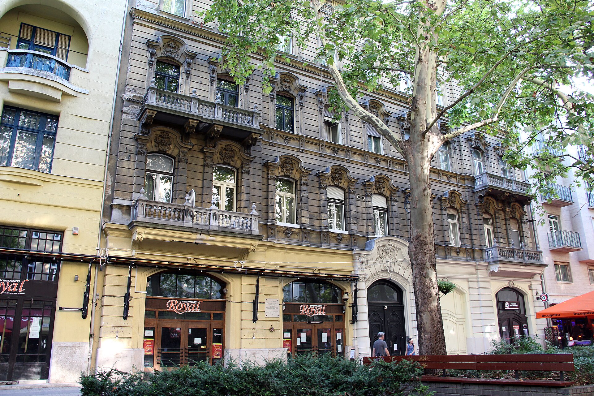 Ornate old apartment buildings with restaurant frontages and plane trees along Liszt Ferenc tér in Budapest’s District VI.