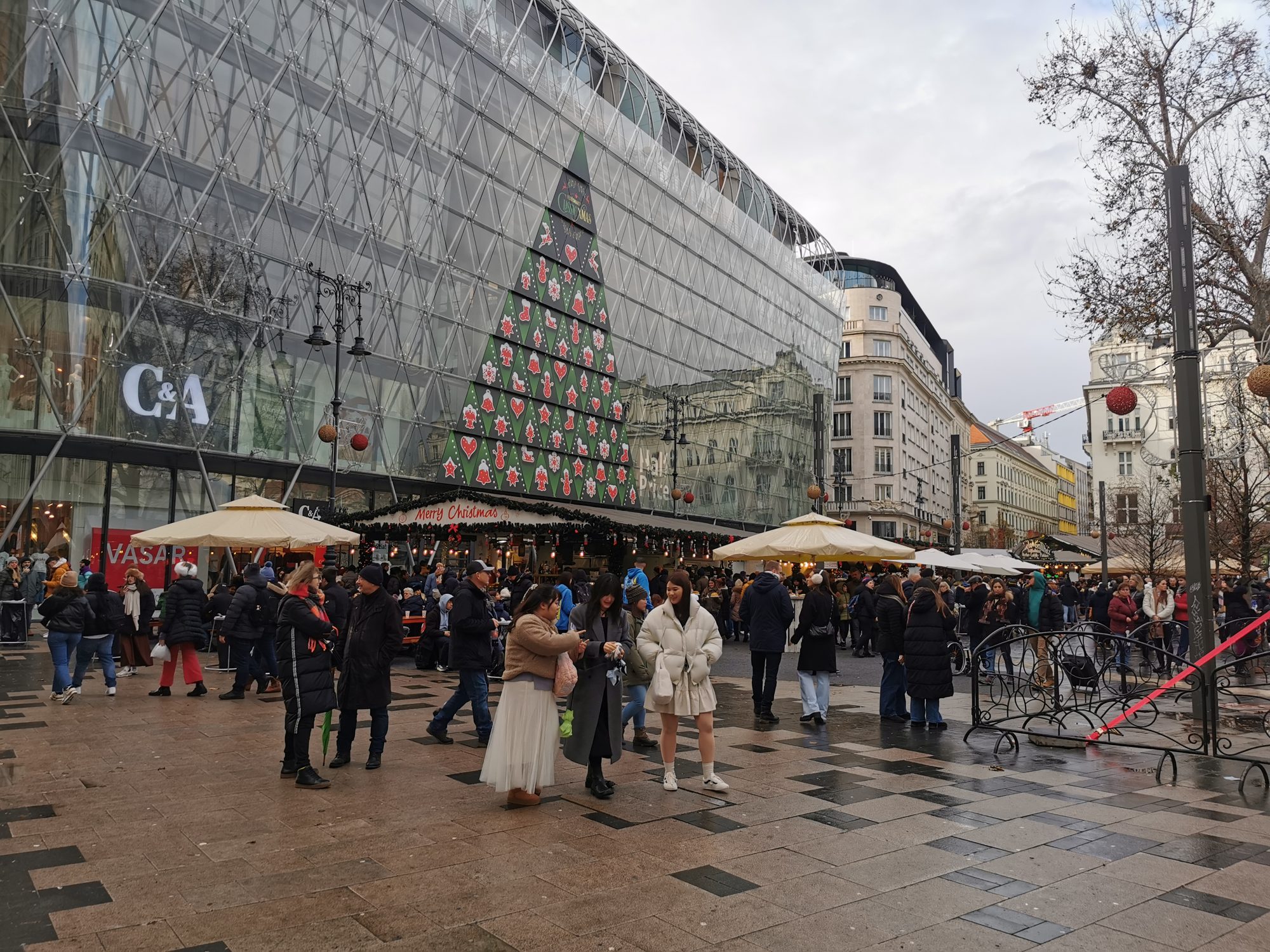 Menschenmassen und Marktstände unter dem Weihnachtsbaum am Vörösmarty tér in Budapest