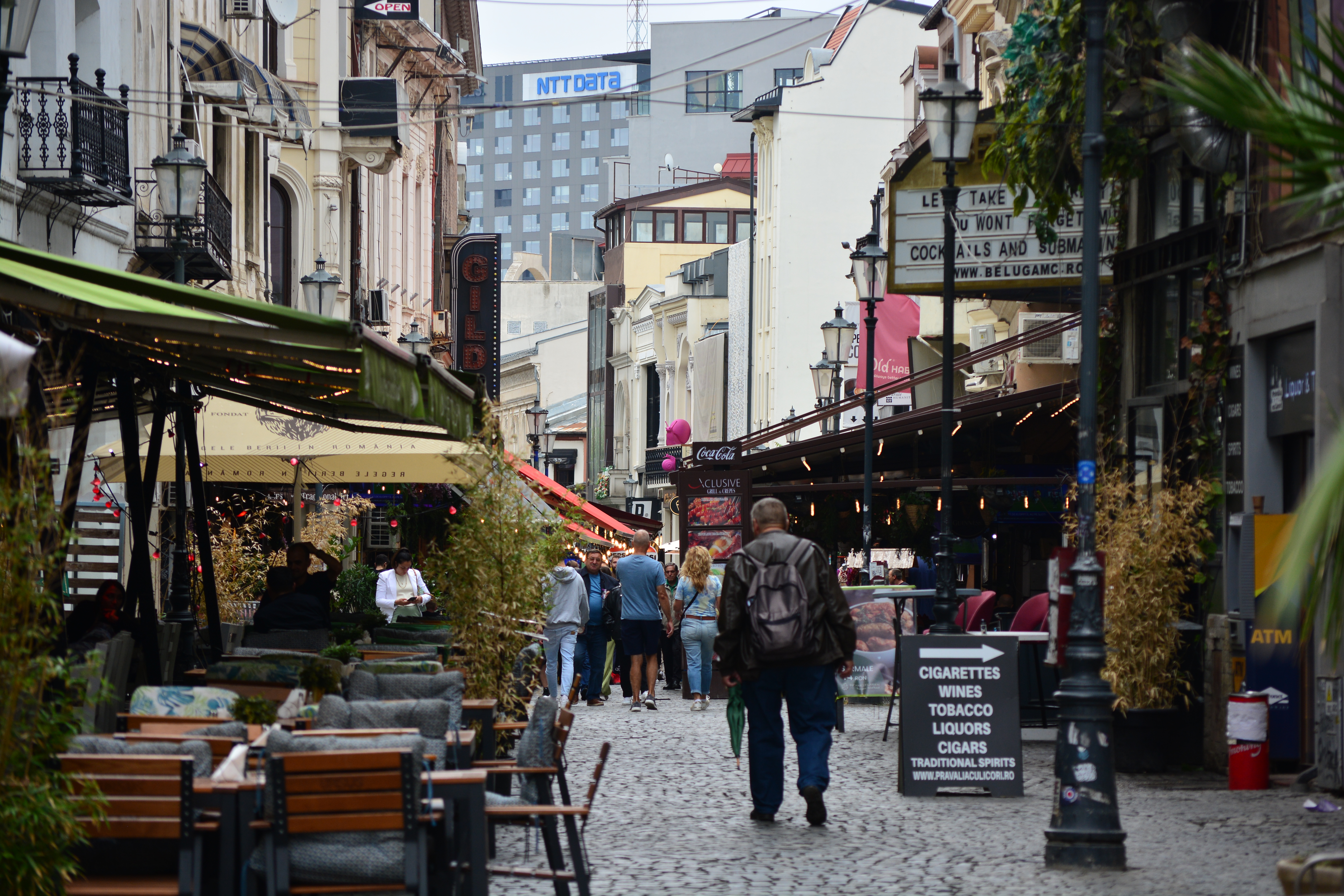 Strada Lipscani in Bucharest old town, bar terraces on both sides of a cobbled street