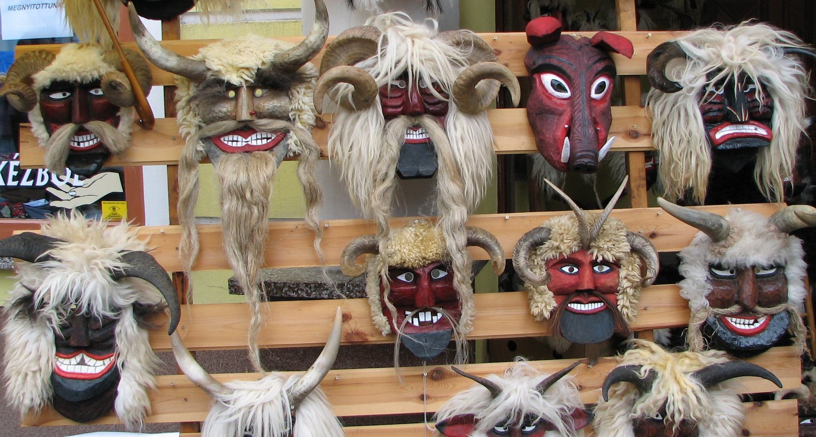 A rack of carved wooden busó masks with horns and sheepskin, on display in Mohács