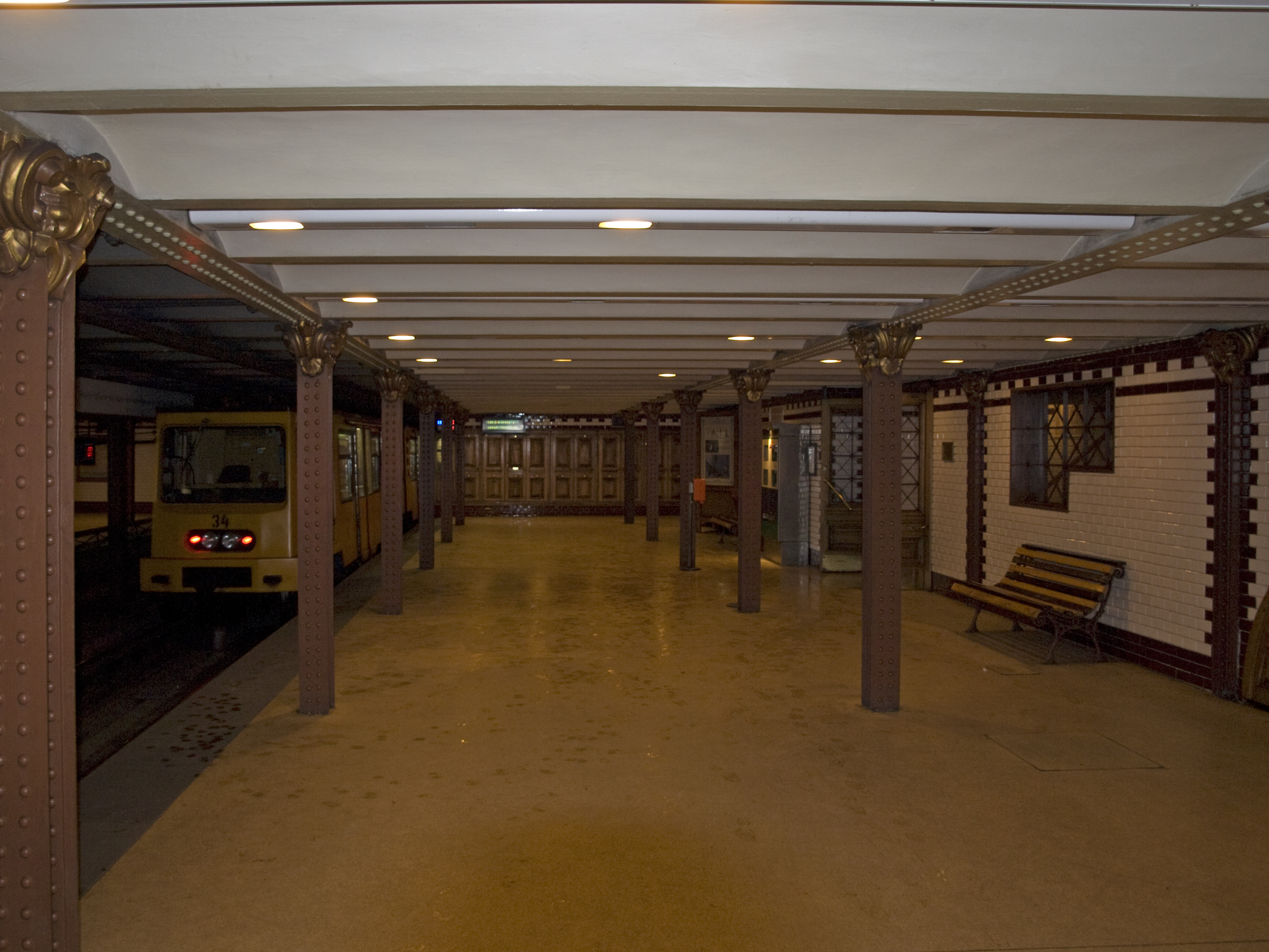 The platform of Opera station on the M1, with its heritage ironwork columns and wood-panelled walls
