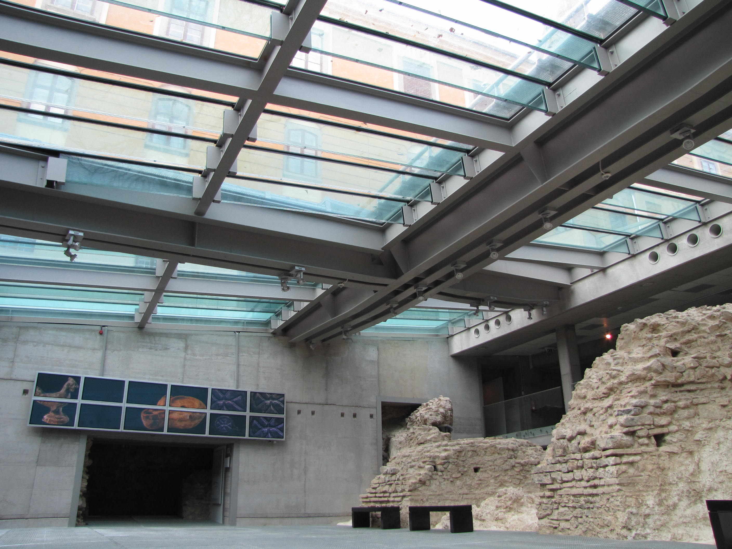 Inside the glass-roofed Cella Septichora visitor centre, looking down onto the excavated Early Christian burial walls