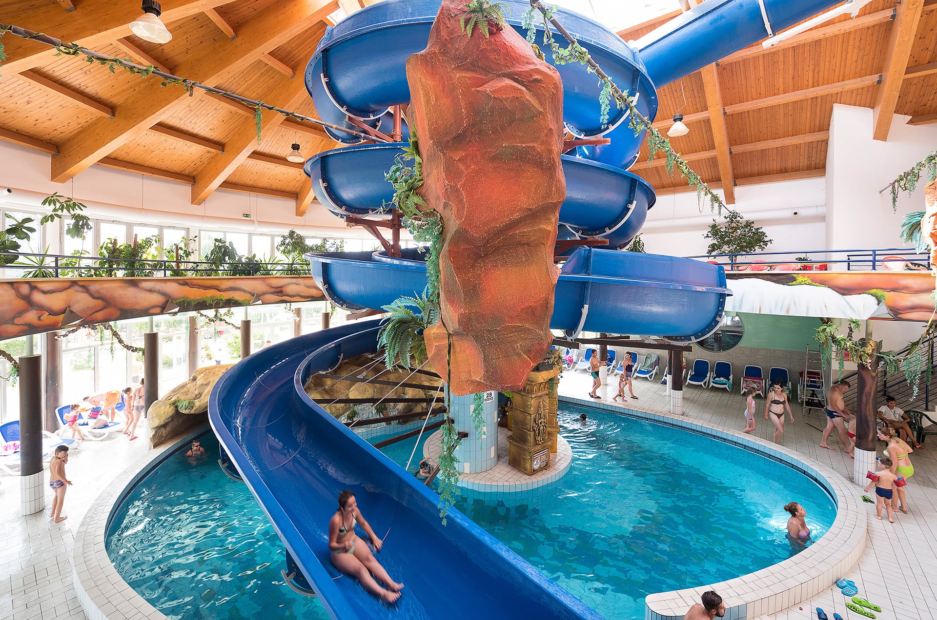 Indoor water slides curling above the adventure pool at Aquarius Élményfürdő