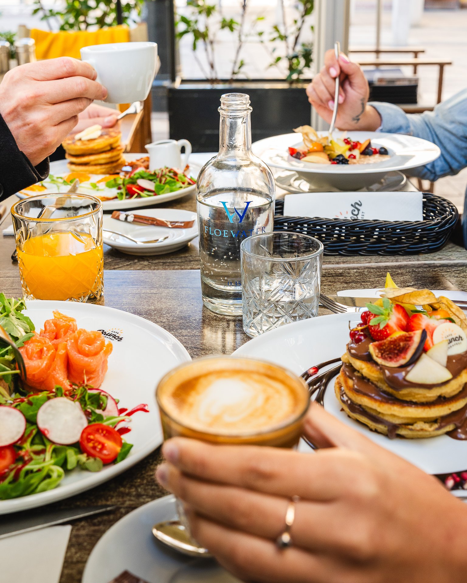 A table at Cafe Brunch Budapest Bazilika with pancakes, a smoked salmon plate and coffee