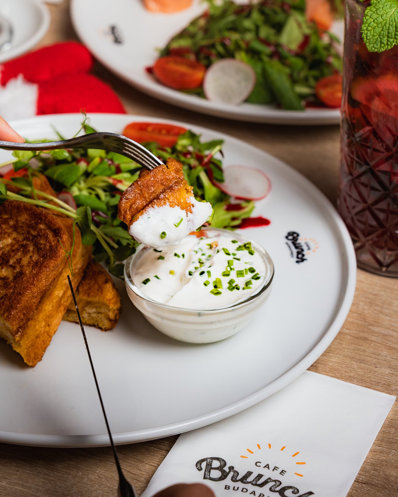 Stuffed bundás kenyér at Brunch Bistro Budapest, a fried egg on top and a side salad