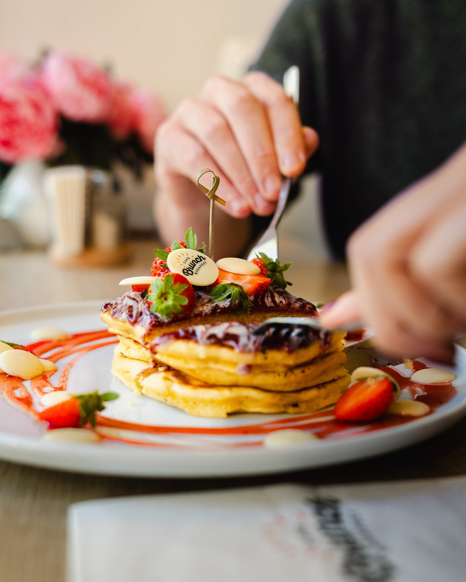 Pancake stack with strawberries and blueberry sauce at Cafe Brunch Budapest Opera