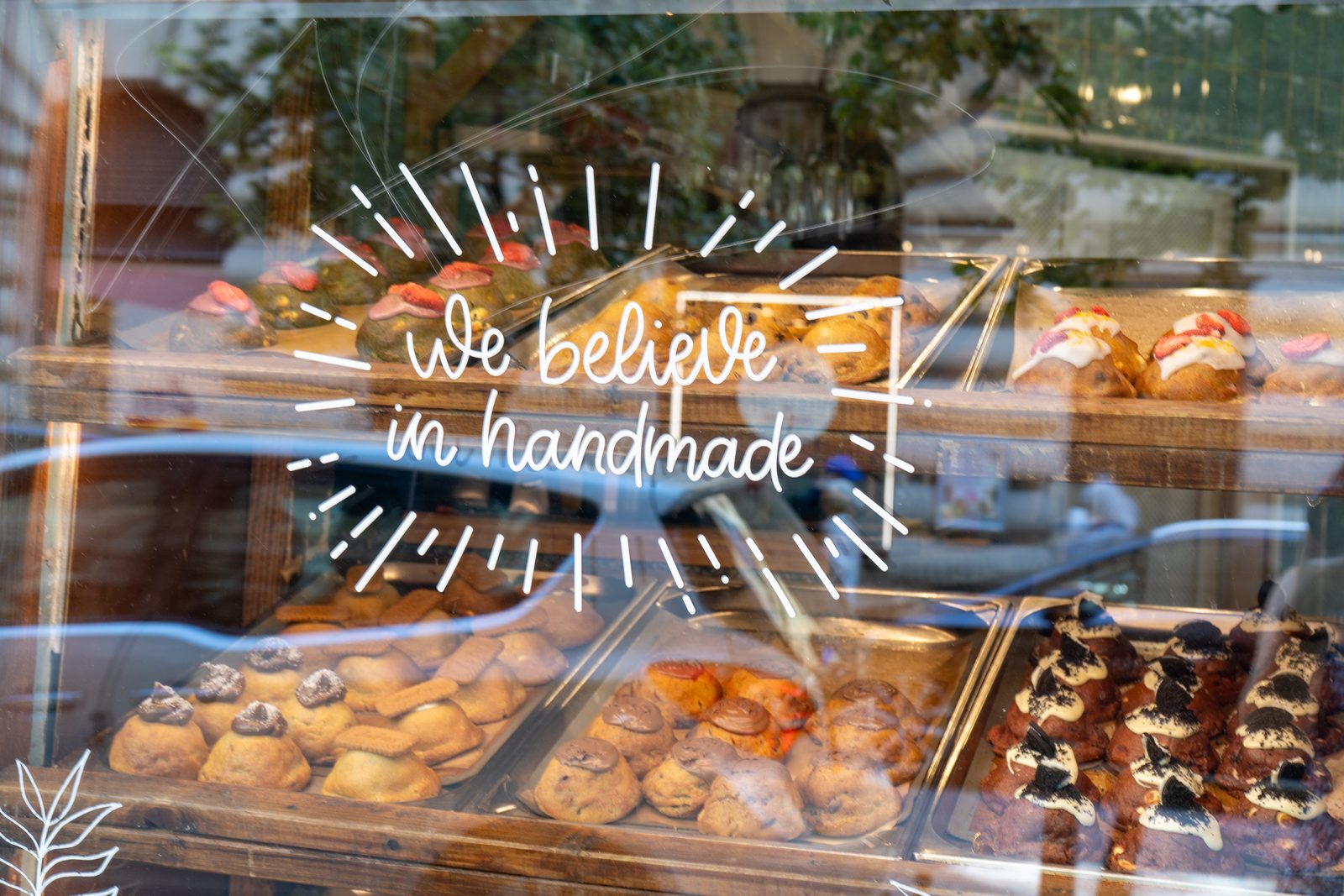 Cookie Beacon’s window on Hercegprímás utca, “we believe in handmade” lettered on the glass over trays of chunky cookies
