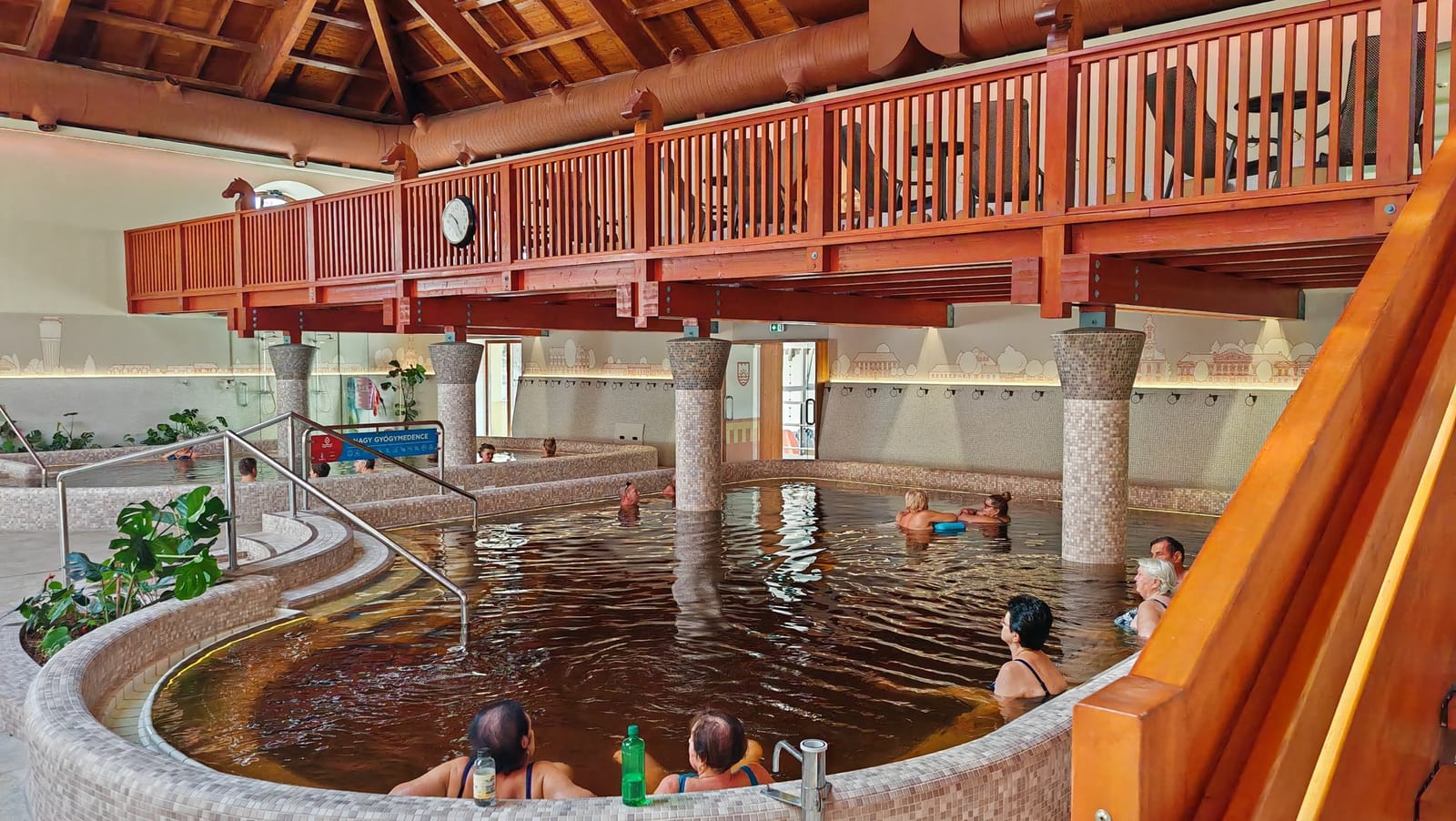 Indoor medicinal pool beneath a wooden gallery at Gyulai Várfürdő