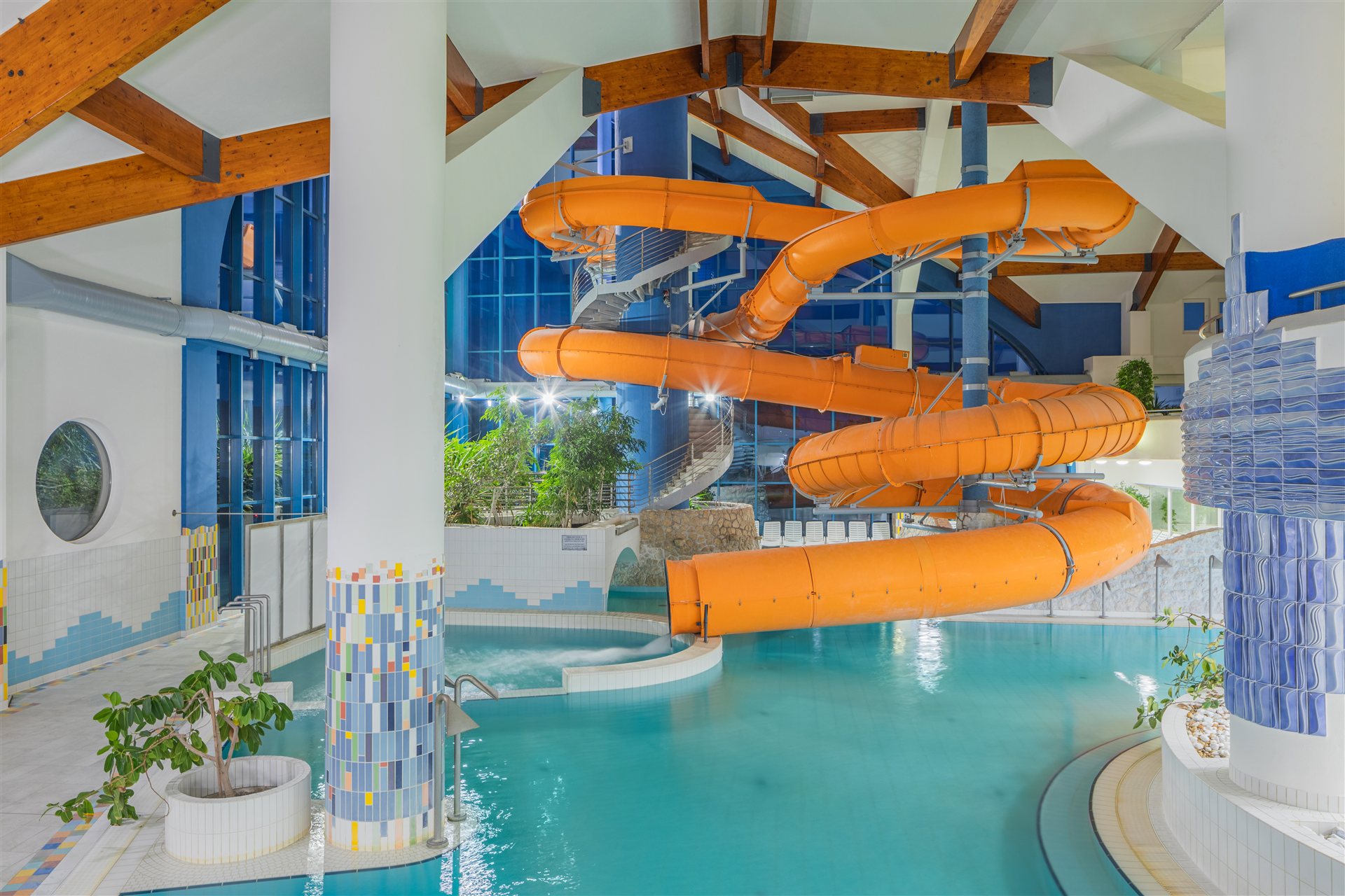 The indoor pool and orange waterslide at Kehida Termál