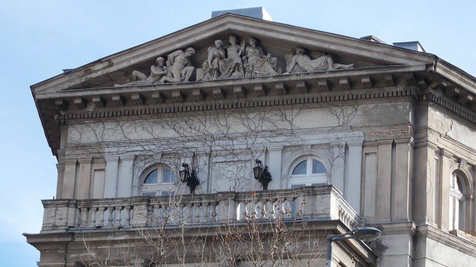The sculpture group in the corner pediment of Bajcsy-Zsilinszky út 37 in Budapest, six mythological figures carved above a balcony