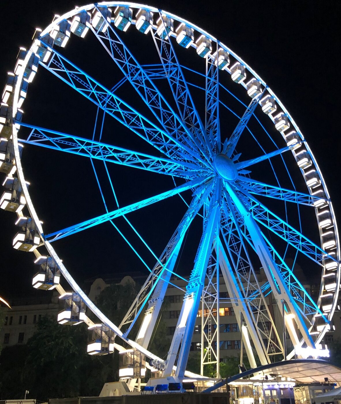The Ferris Wheel of Budapest at night, its spokes lit blue and its cabins lit white