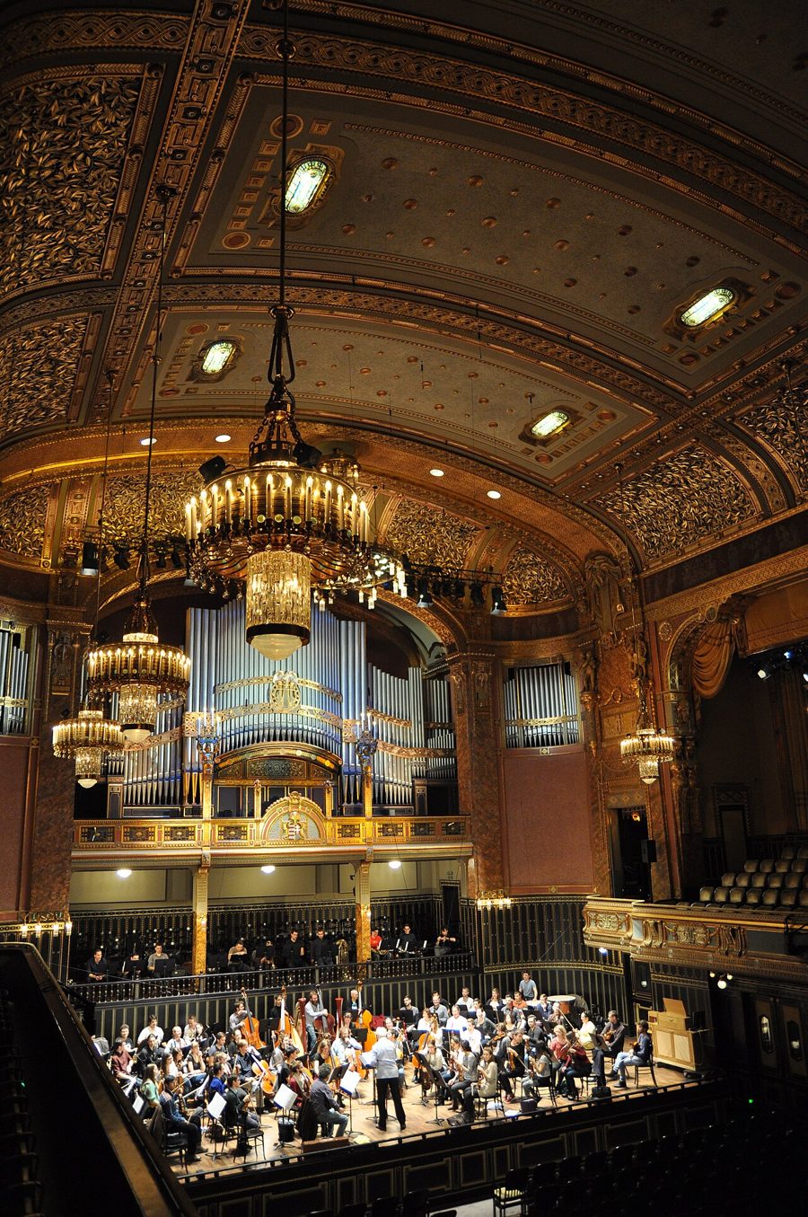 The Grand Hall of the Liszt Academy, with its organ, chandeliers and gilded ceiling above an orchestra on stage