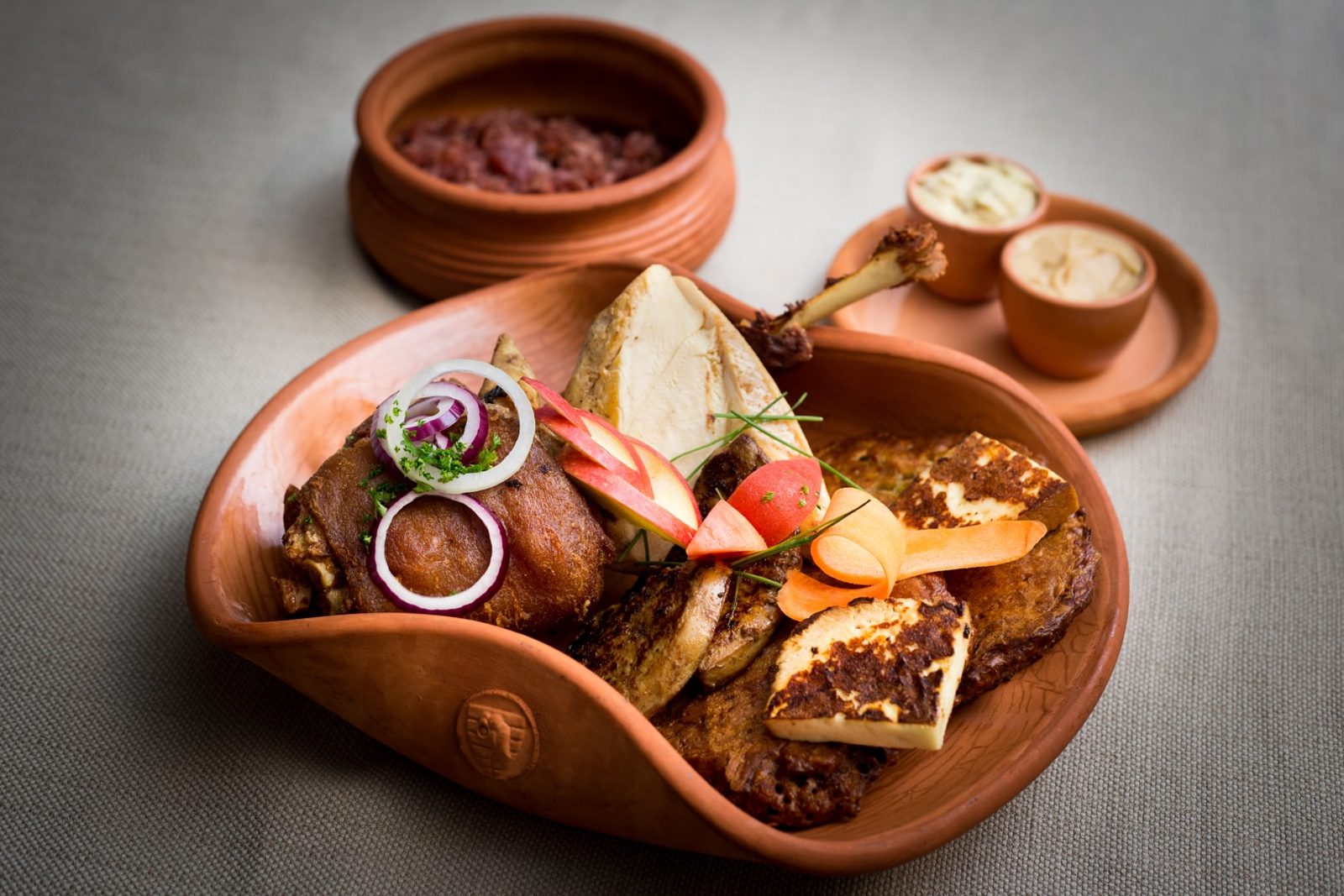 King Matthias’s Favorite Roasts served on a clay platter at the Renaissance restaurant, with roast meats, vegetables and dips
