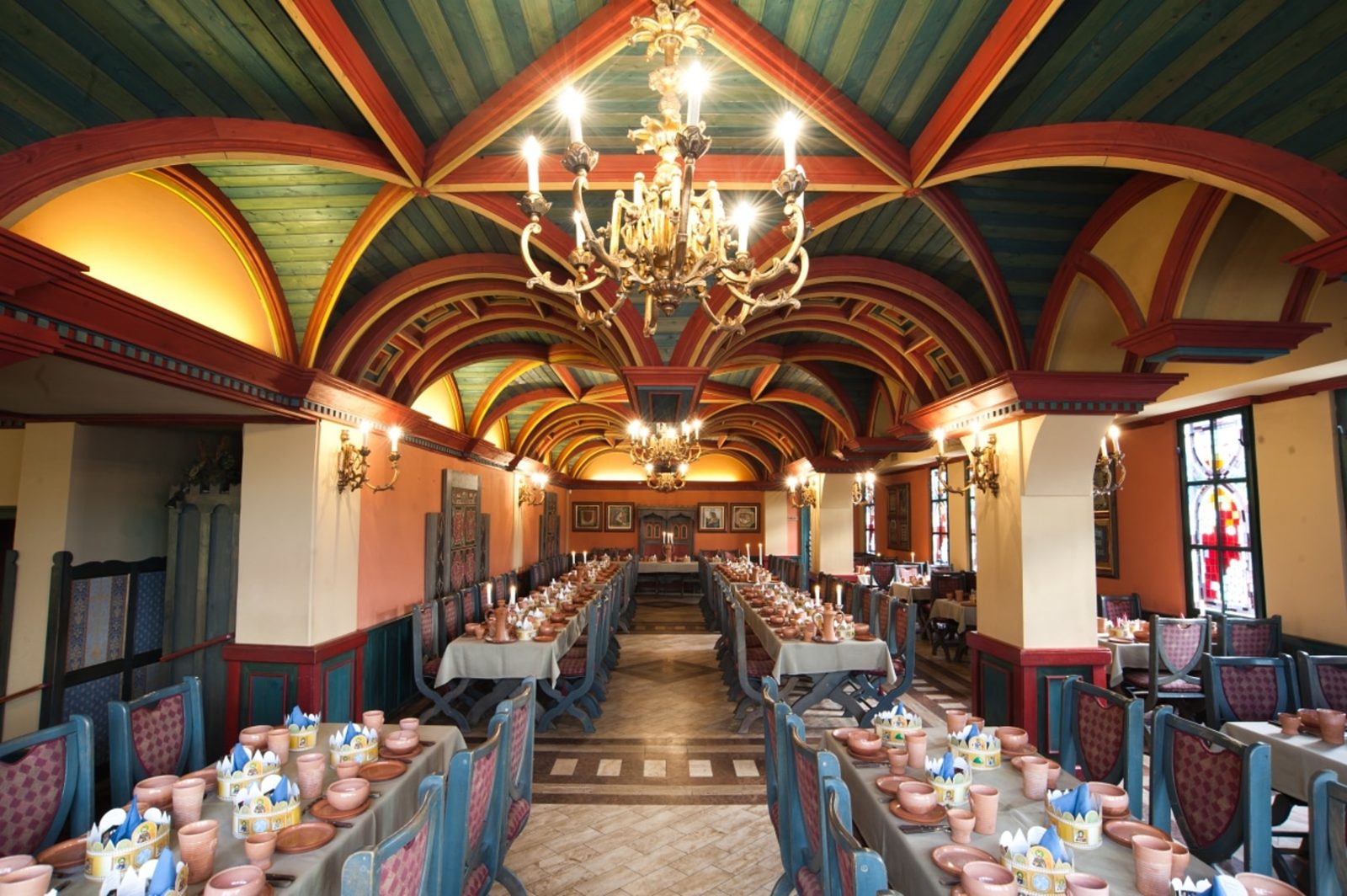 The Throne Room at the Renaissance restaurant in Visegrád, long tables under a painted vaulted ceiling and chandeliers
