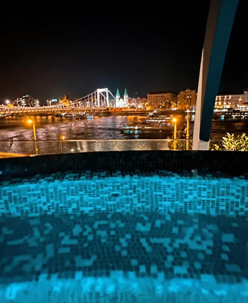 Rudas Bath wellness pool with panoramic Danube views through floor-to-ceiling windows