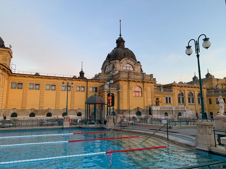 Széchenyi Thermal Bath outdoor swimming pool with the iconic yellow Neo-Baroque building in Budapest